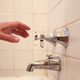 Image for article titled Man Approaches Unfamiliar Shower Knobs Like He Breaking Wild Stallion